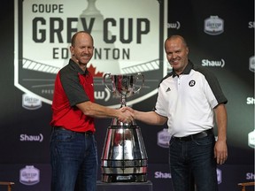 Calgary Stampeders head coach Dave Dickenson (left) and Ottawa REDBLACKS head coach Rick Campbell (right) shake hands before addressing the media in Edmonton on Wednesday November 21, 2018. The two teams will face off in the 106th CFL Grey Cup Championship game on Sunday November 25, 2018 at Commonwealth Stadium in Edmonton.