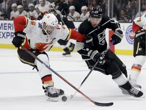Los Angeles Kings left wing Ilya Kovalchuk, right, knocks the puck away from Calgary Flames defenseman Mark Giordano during the second period of an NHL hockey game in Los Angeles, Saturday, Nov. 10, 2018.