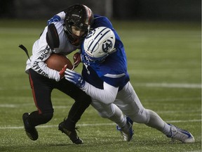 Harry Ainlay Titans Evan Jones tackles Salisbury Sabres Nolan Carwell in the Provincial High School North semifinal game on Friday, Nov. 9, 2018 in Edmonton.