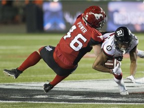 Calgary Stampeders Charlie Power (46) tackles  Ottawa Redblacks Diontae Spencer (85) during the 106th Grey Cup game on Sunday, Nov. 25, 2018, in Edmonton.