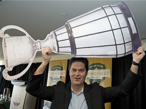 Duane Vienneau Executive Director of the 2018 Grey Cup Festival holds a mock Grey Cup over his head at an announcement for the 106th CFL Grey Cup Championship held at the Shaw Conference Centre in Edmonton on Friday May 11, 2018.