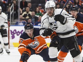 Los Angeles Kings centre Anze Kopitar is chased by Edmonton Oilers star Connor McDavid and defenceman Brandon Davidson during NHL action in Edmonton on Jan. 2, 2018.