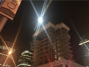 Police and fire crews work to rescue a person who climbed a crane in downtown Edmonton on Sunday, Nov. 11, 2018.