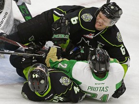 Prince Albert Raiders Brett Leason is checked by Edmonton Oil Kings Wyatt McLeod (top) and Carter Souch (bottom) during third  period WHL hockey game action in Edmonton on Nov. 28, 2018.