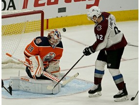 Edmonton Oiler goalie Mikko Koskinen makes a save on Colorado Avalanche winger Gabriel Landeskog (right) during third period NHL hockey game action in Edmonton on Sunday Nov. 11, 2018.