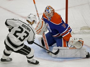 Edmonton Oilers goalie Mikko Koskinen (right) makes a save on Los Angeles Kings Dustin Brown (left) during second period NHL hockey game action in Edmonton on Thursday November 29, 2018.