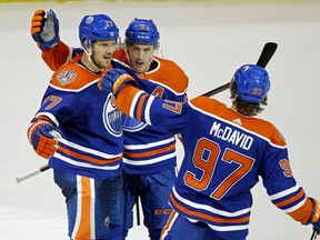 Edmonton Oilers Oscar Klefbom (left) celebrates his game winning goal late in the third period with team mates Ryan Nugent-Hopkins (middle) and Connor McDavid (right) during third period NHL hockey game action in Edmonton on Thursday November 29, 2018.
