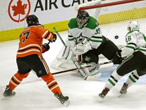 Edmonton Oilers defenceman Oscar Klefbom (left) scores in overtime against Dallas Stars goalie Anton Khudobin as Stars Jason Dickinson (right) watches the puck go into the net. The Oilers defeated the Stars by a score of 1-0 in NHL hockey game action in Edmonton on Tuesday November 27,2018.