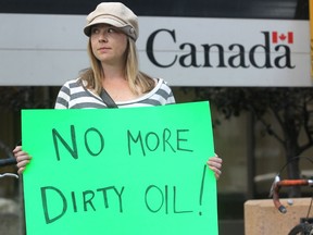 Colleen De Neve, Calgary Herald CALGARY, AB: SEPTEMBER 26, 2011 -- Anti Keystone pipeline and oilsands protestor Robyn Luff held a sign as she gathered with other protestors outside the Harry Hays Building in Calgary on September 26, 2011 to voice their opposition to the project.