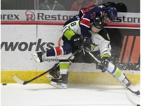 Regina Pats Garrett Wright, top, fights for the loose puck with Edmonton Oil Kings Ethan Cap at the Brandt Centre in Regina on Nov. 2, 2018.