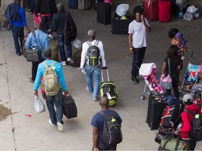 New refugees arrive at Olympic Stadium in Montreal, Aug. 5, 2017.