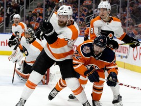 The Edmonton Oilers' Tobias Rieder (22) battles the Philadelphia Flyers' Sean Couturier (14) during first period NHL action at Rogers Place, in Edmonton Friday Dec. 14, 2018. Photo by David Bloom