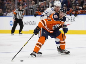 Edmonton Oilers' Connor McDavid (97) battles the Tampa Bay Lightning' Brayden Point (21) during first period NHL action at Rogers Place, in Edmonton Saturday Dec. 22, 2018.