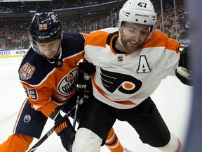 The Edmonton Oilers' Alex Chiasson (39) battles the Philadelphia Flyers' Andrew MacDonald (47) during first period NHL action at Rogers Place, in Edmonton Friday Dec. 14, 2018.