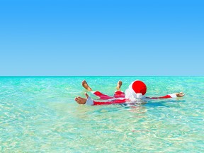 Santa Claus take pleasure swimming in ocean water.