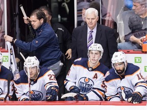 Edmonton Oilers head coach Ken Hitchcock, back right, stands on the bench behind Alex Chiasson, from left to right, Tobias Rieder, of Germany, Ryan Nugent-Hopkins and Jujhar Khaira during second period NHL hockey action against the Vancouver Canucks, in Vancouver on Sunday, Dec. 16, 2018.