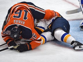 Edmonton Oilers Jujhar Khaira (16) falls over St. Louis Blues Vince Dunn (29) after cross checking him which he received a five minute penalty and a game misconduct in NHL action at Rogers Place in Edmonton, December 18, 2018.