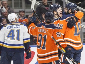 St. Louis Blues' Robert Bortuzzo (41) skates past as Edmonton Oilers' Drake Caggiula (91), Jesse Puljujarvi (98) and Jujhar Khaira (16) celebrate a goal during second period NHL action in Edmonton, Alta., on Tuesday December 18, 2018.