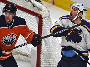 St. Louis Blues Patrick Maroon (7) reacts after getting Edmonton Oilers Kevin Gravel's (5) stick in the face in NHL action at Rogers Place in Edmonton, December 18, 2018.