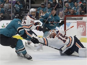 Edmonton Oilers goaltender Mikko Koskinen, from Finland, bottom right, defends a shot by San Jose Sharks right wing Timo Meier (28), from Switzerland, during the first period of an NHL hockey game in San Jose, Calif., Tuesday, Nov. 20, 2018.