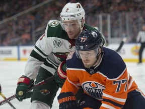 Oscar Klefbom of the Edmonton Oilers, is chased down by Charlie Coyle of the Minnesota Wild at Rogers Place in Edmonton on  December 7, 2018.