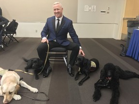 Ex-CFL quarterback Matt Dunigan and the Aspen Service Dogs (SUPPLIED)