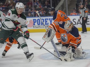 Cam Talbot of the Edmonton Oilers, makes the stop as Joel Eriksson Ek of the Minnesota Wild is waiting for the rebound at Rogers Place in Edmonton on  December 7, 2018.