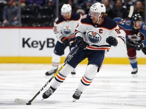Edmonton Oilers center Connor McDavid drives down the ice with the puck against the Colorado Avalanche in the second period of an NHL hockey game on Tuesday, Dec. 11, 2018, in Denver.
