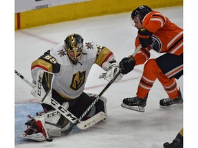 Edmonton Oilers Ty Rattie (8) can't jam the puck past Vegas Golden Knights goalie Marc-Andre Fleury (29) during NHL action at Rogers Place in Edmonton, December 1, 2018.