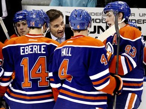 Edmonton head coach Dallas Eakins speaks with his players during a timeout called in the third period of a NHL game as the Edmonton Oilers play the Pittsburgh Penguins at Rexall Place in Edmonton on Jan. 10, 2014.