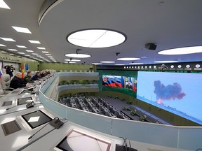 Russian Defence Minister Sergei Shoigu, fourth left, Russian President Vladimir Putin, fifth left, Chief of General Staff of Russia Valery Gerasimov, sixth left, and other top officials oversee the test launch of the Avangard hypersonic glide vehicle from the Defence Ministry's control room in Moscow, Russia, Wednesday, Dec. 26, 2018.
