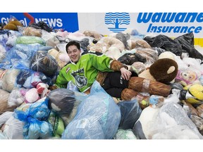 Edmonton Oil Kings Jalen Luypen (23) lies in a pile of teddy bears after scoring the first goal of the annual Teddy Bear Toss game in the second period against the Kamloops Blazers on Saturday, Dec. 8, 2018, at in Edmonton.