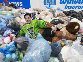 Edmonton Oil Kings Jalen Luypen (23) lies in a pile of teddy bears after scoring the first goal of the annual Teddy Bear Toss game in the second period against the Kamloops Blazers on Saturday, Dec. 8, 2018, at in Edmonton.