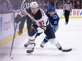 Ryan Nugent-Hopkins #93 of the Edmonton Oilers skates with the puck while pursued by Loui Eriksson #21 of the Vancouver Canucks in NHL action on January, 16, 2019 at Rogers Arena in Vancouver.