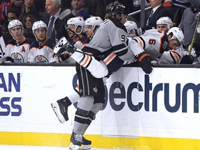 LOS ANGELES, CALIFORNIA - JANUARY 05:  Adrian Kempe #9 of the Los Angeles Kings pushes Adam Larsson #6 of the Edmonton Oilers over the boards during the first period at Staples Center on January 05, 2019 in Los Angeles, California. (Photo by Harry How/Getty Images)