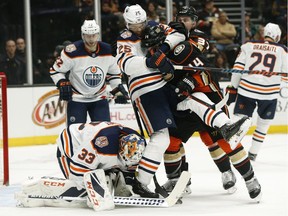 Darnell Nurse #25 of the Edmonton Oilers and Adam Henrique #14 of the Anaheim Ducks fight in front of the Edmonton Oilers goal during the first period at Honda Center on January 06, 2019 in Anaheim, California.