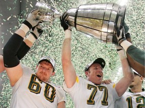 Edmonton Eskimos captains Chris Morris and A.J. Gass hoist the Grey Cup after defeating the Montreal Alouettes to win the Grey Cup at B.C. Place in Vancouver, B.C., on Sunday November 27, 2005.n/a