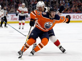 The Edmonton Oilers' Connor McDavid battles the Florida Panthers' Aleksander Barkov during second period NHL action at Rogers Place on Thursday, Jan. 10, 2019.