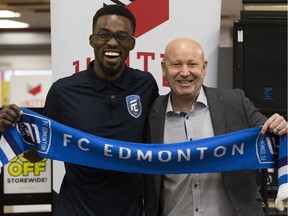Tomi Ameobi and FC Edmonton head coach and director of soccer operations Jeff Paulus pose for a photo during a press conference where it was officially announced that Ameobi is returning to FC Edmonton, in Edmonton on Thursday Jan. 31, 2019.