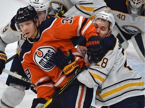 Edmonton Oilers Alex Chiasson (39) gets his elbow in the face of Buffalo Sabres Zemgus Girgensons (28) during NHL action at Rogers Place in Edmonton, January 14, 2019.