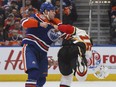 Calgary Flames' Anthony Peluso (16) and Edmonton Oilers' Milan Lucic (27) fight during first period NHL action in Edmonton on Sunday, Dec. 9, 2018.