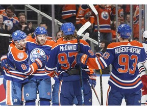 Edmonton Oilers' Ty Rattie (8), Leon Draisaitl (29), Connor McDavid (97) and Ryan Nugent-Hopkins (93) celebrate a goal during second period NHL action against the Winnipeg Jets, in Edmonton on Monday, Dec. 31, 2018.