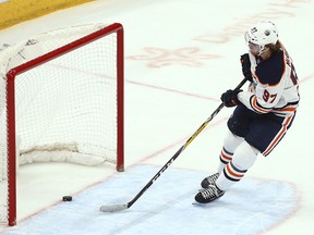 Edmonton Oilers center Connor McDavid scores an empty-net goal against the Arizona Coyotes during the third period of an NHL hockey game Wednesday, Jan. 2, 2019, in Glendale, Ariz. The Oilers won 3-1. (AP Photo/Ross D. Franklin) ORG XMIT: PNJ115