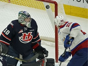 Lethbridge Hurricanes goalie Liam Highes (left) makes a save on Edmonton Oil Kings David Kope (right) during first period WHL hockey game action in Edmonton on Sunday January 6, 2018.