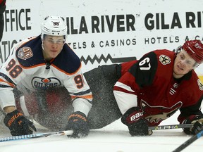 Edmonton Oilers right wing Jesse Puljujarvi (98) and Arizona Coyotes left wing Lawson Crouse (67) collide into the boards during the first period of an NHL hockey game Wednesday, Jan. 2, 2019, in Glendale, Ariz. (AP Photo/Ross D. Franklin) ORG XMIT: PNJ103