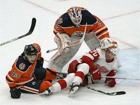 Edmonton Oilers goalie Mikko Koskinen pushes away Detroit Red Wings Christoffer Ehn after he collided with Oilers defenceman Matt Benning (left) during second period NHL hockey game action in Edmonton on Tuesday, Jan. 22, 2019.