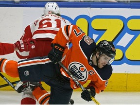 Edmonton Oilers captain Connor McDavid is checked by Detroit Red Wings Jacob de la Rose during third period NHL hockey game action in Edmonton on Tuesday January 22, 2019.