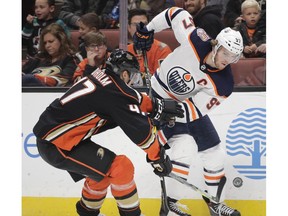 Edmonton Oilers' Connor McDavid, right, is pressured by Anaheim Ducks' Hampus Lindholm, of Sweden, during the first period of an NHL hockey game Sunday, Jan. 6, 2019, in Anaheim, Calif.