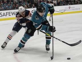 San Jose Sharks right wing Joonas Donskoi (27), from Finland, tries to get the puck in front of Edmonton Oilers defenseman Caleb Jones (82) during the first period of an NHL hockey game in San Jose, Calif., Tuesday, Jan. 8, 2019.