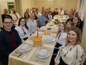 Paul Jereniuk (front left) and his wife Marsha Jereniuk (front right) hosted a family dinner on Sunday to celebrate Orthodox Christmas.
